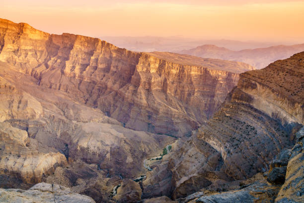 Scenic view of Wadi Ghul aka Grand Canyon of Arabia in Jebel Shams, Oman at sunset